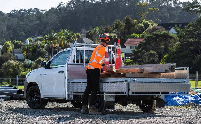 Toyota Hilux flat deck ute on construction site.